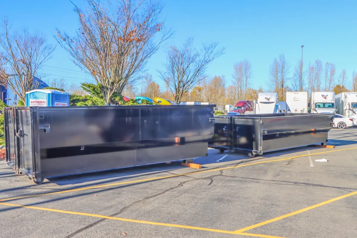 Professional dumpster rental service with roll-off container on residential driveway in Ecorse